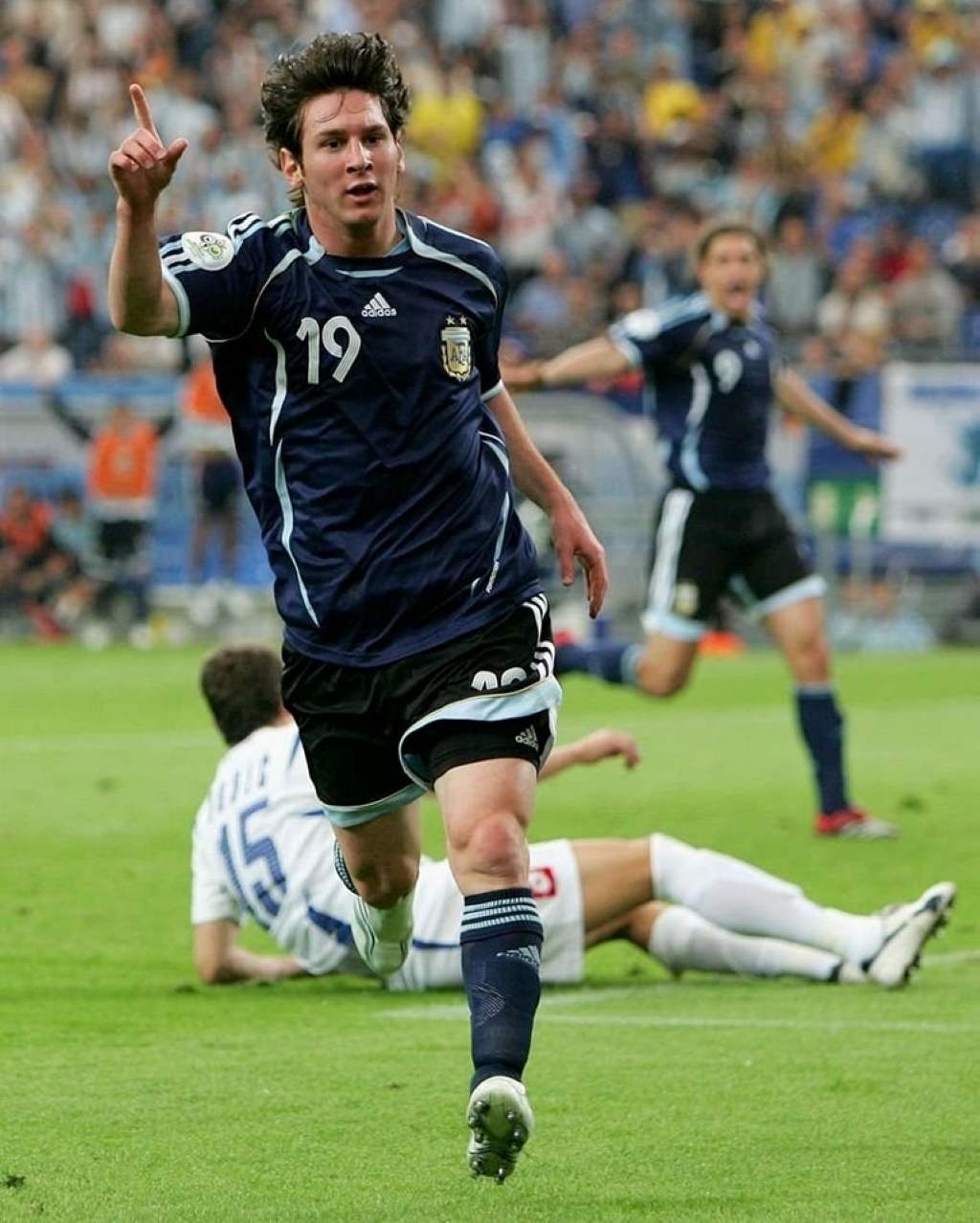 Young debutant receiving first cap shirt from Lionel Messi before Argentina match