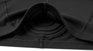 Close-up of black women's padded cycling shorts showing chamois padding detail and stretchy moisture-wicking fabric with leg grippers