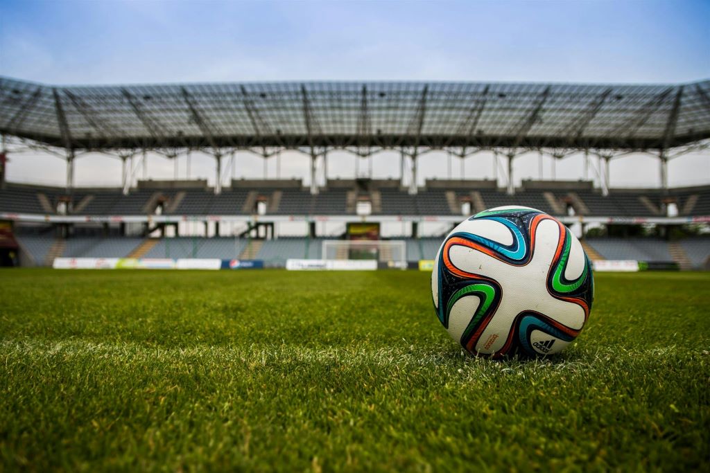Soccer fans analyzing live match tactics in Texas stadium atmosphere