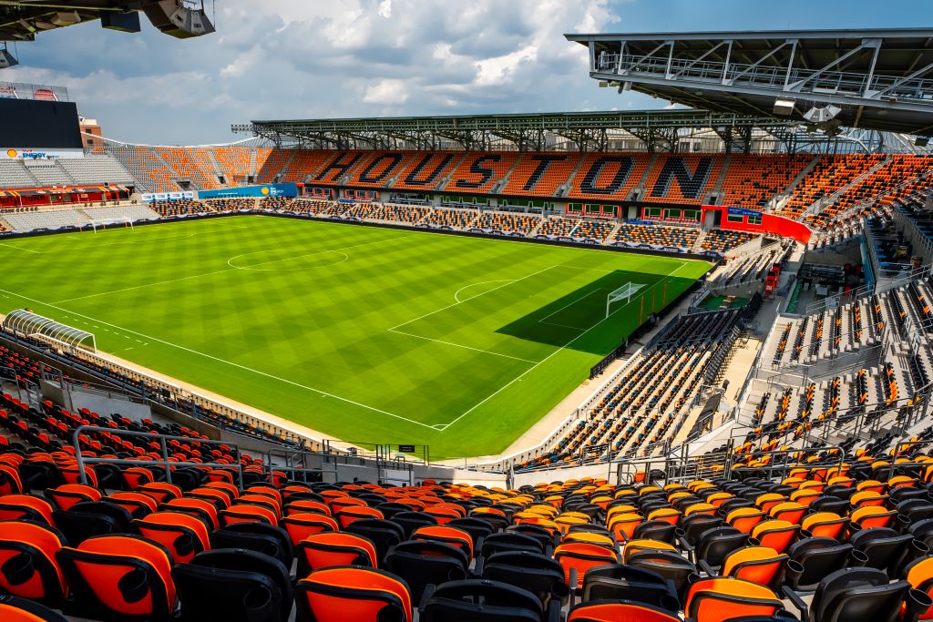 Supporters watching soccer game strategy and player movement like expert fans in Texas