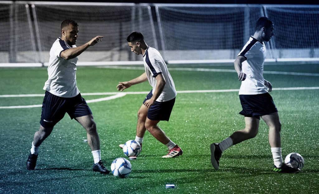 Soccer player doing fitness drills outdoors in Texas TX to improve stamina without gym equipment