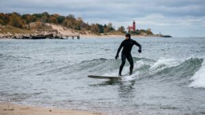 Surfer riding waves on Lake Michigan during autumn